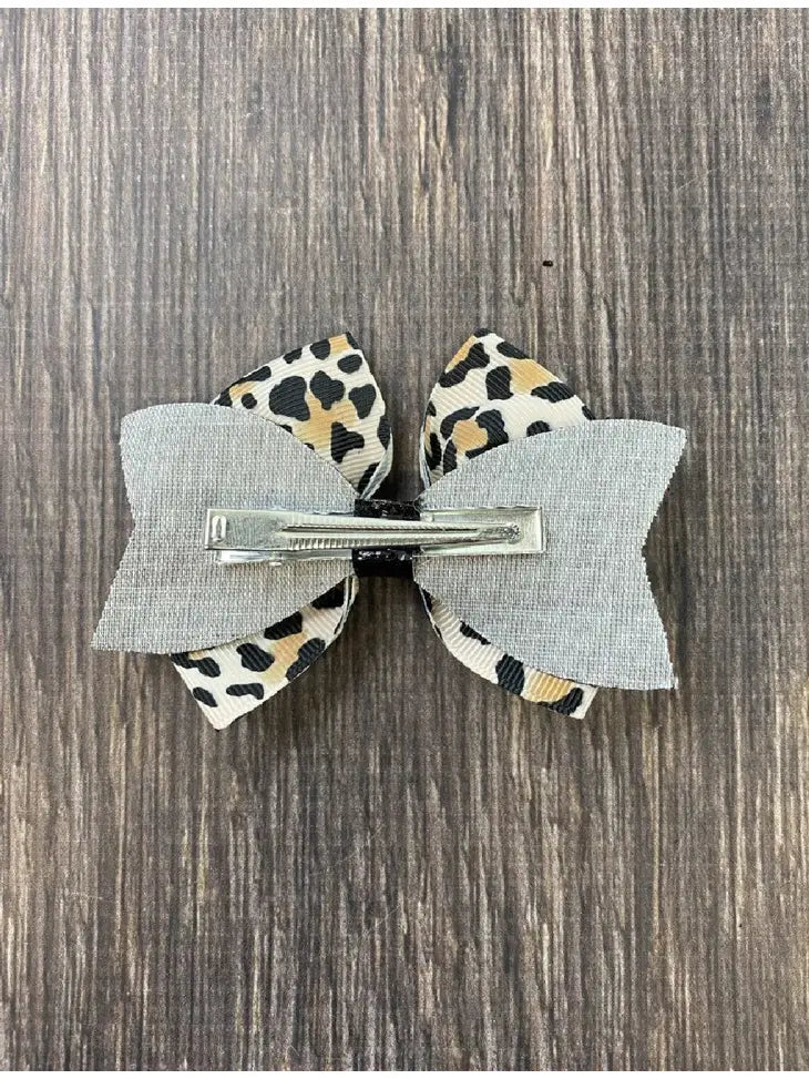 Animal print and black glitter bow on a single alligator clip- approximately 4 inches across. - Brazos Avenue Market 